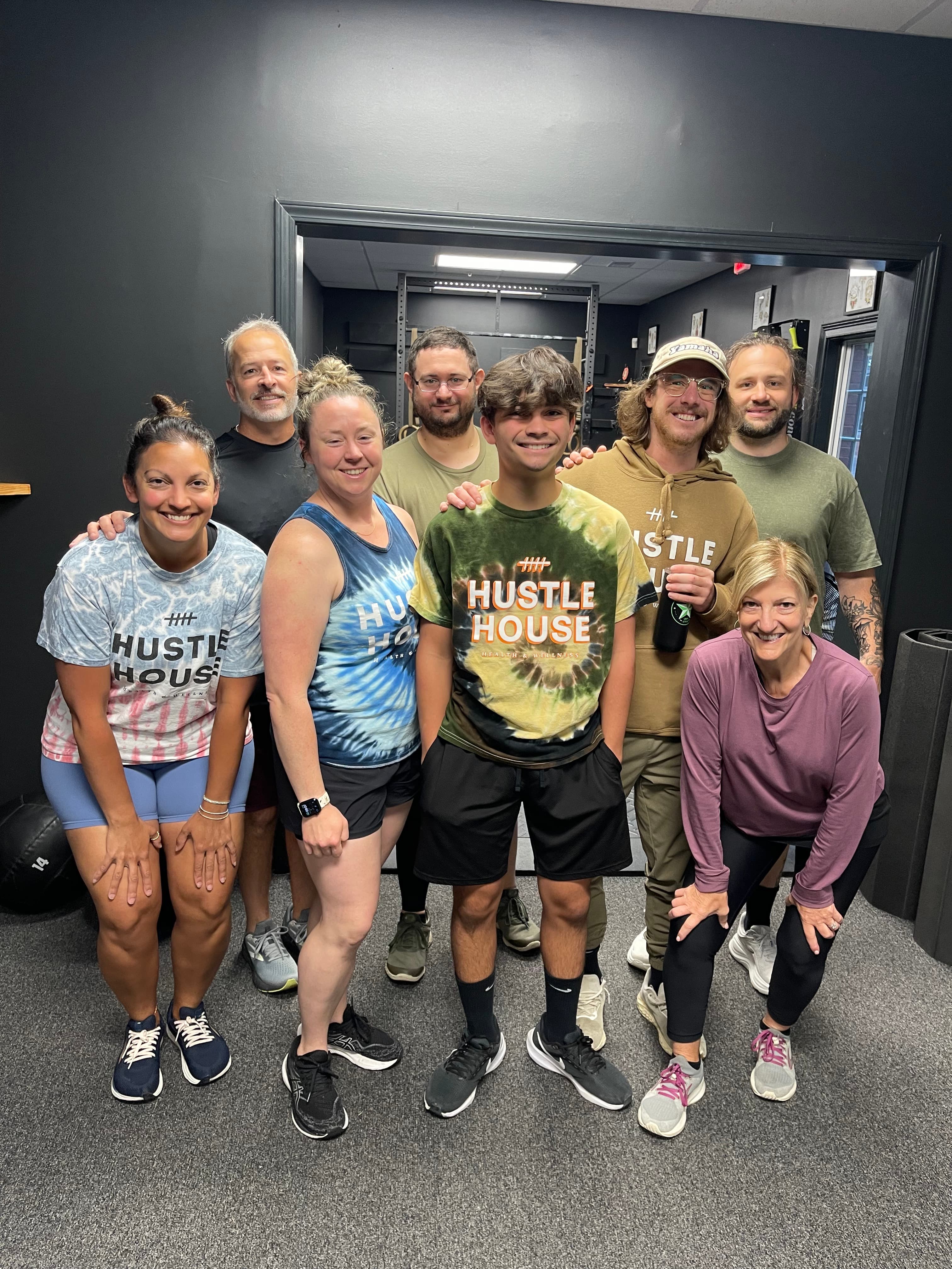 A group of members together after class at Hustle House Health & Wellness in Woodstock, GA
