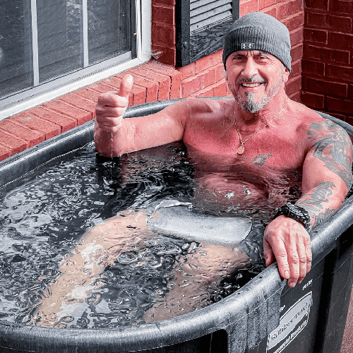 A member sitting in the guided cold plunge ice bath at Hustle House Health & Wellness in Woodstock, GA