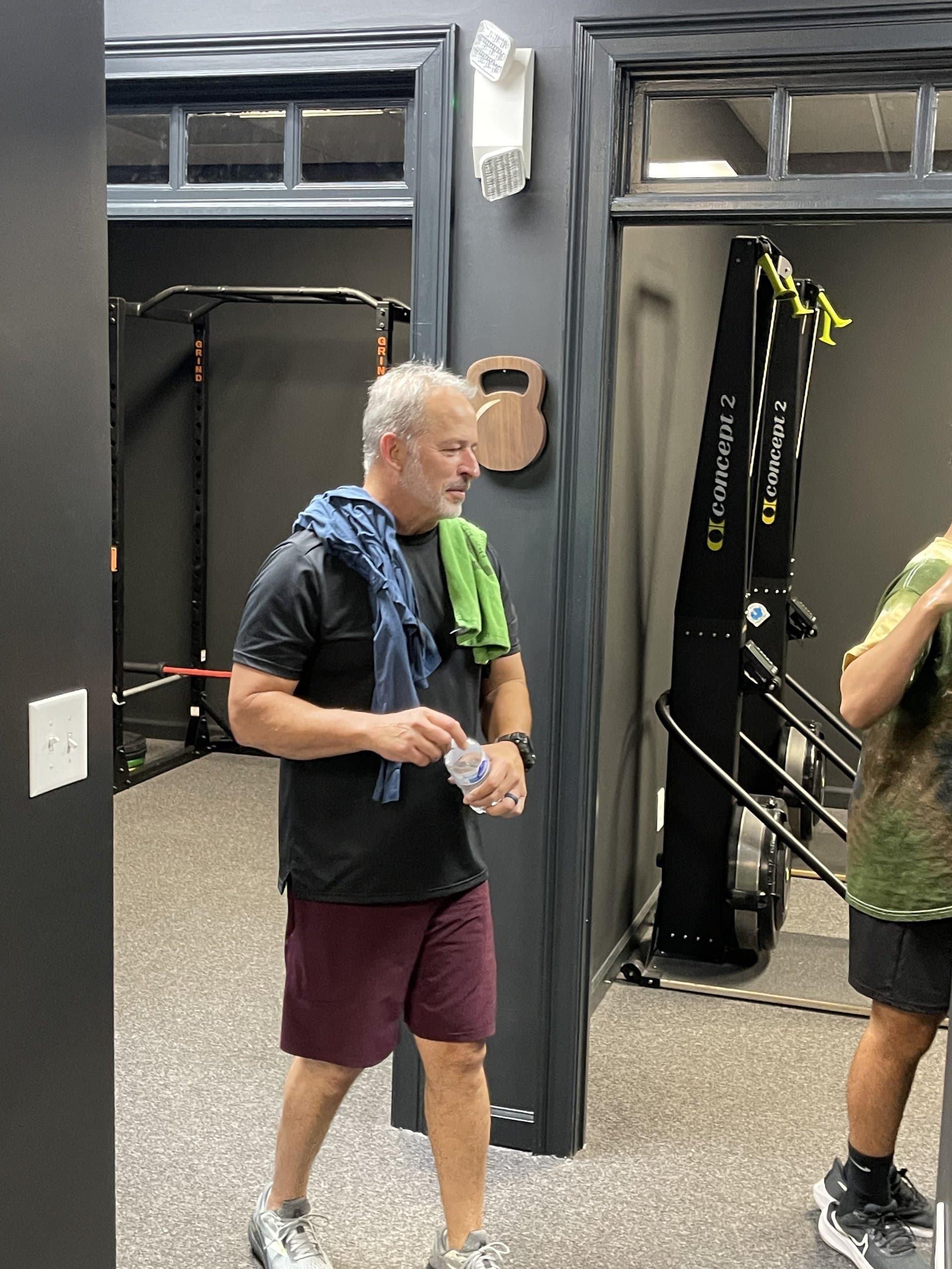 A member taking a water break between rooms at Hustle House Health & Wellness in Woodstock, GA