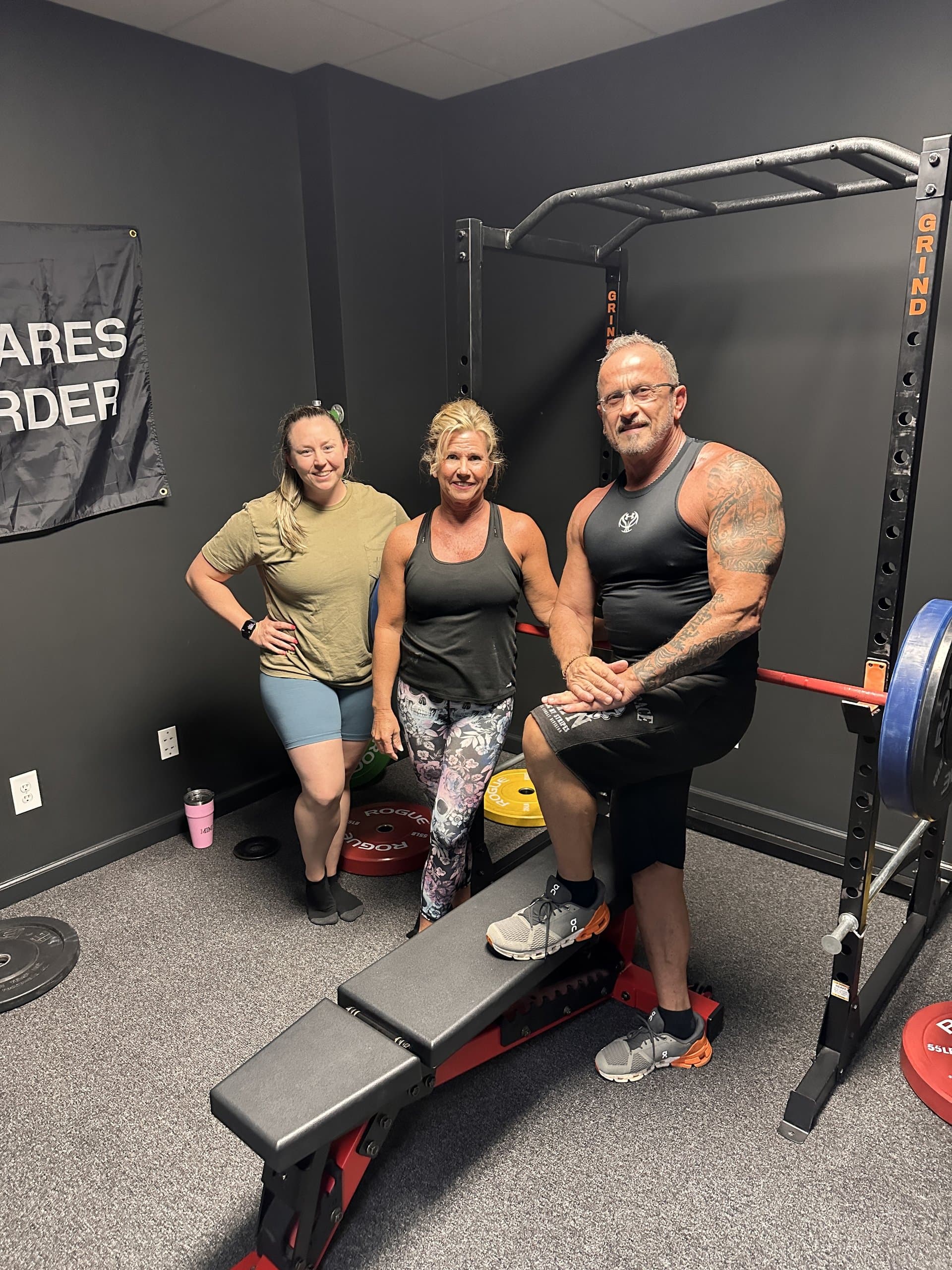 Members and coaches beside the power rack at Hustle House Health & Wellness in Woodstock, GA